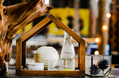 Close-up of illuminated lamp on table in restaurant