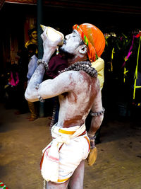Full length of man standing in traditional clothing at night