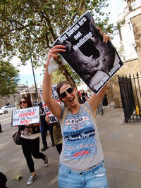 Full length of young woman standing against built structure