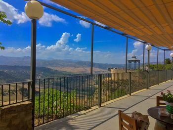 Scenic view of balcony and mountains against sky