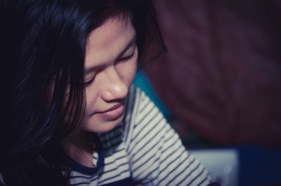 Close-up portrait of young woman with eyes closed