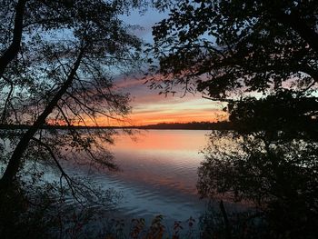 Scenic view of lake against romantic sky at sunset