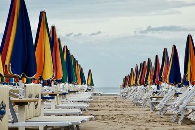 Panoramic view of lounge chairs on beach