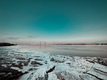 Scenic view of snow covered landscape against blue sky