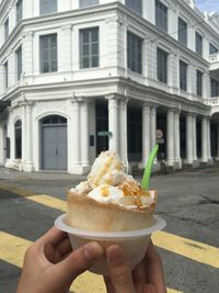 Close-up of hand holding ice cream cone