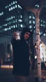 Reflection of young woman in drinking glass