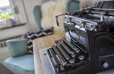 Close-up of old typing machine on table