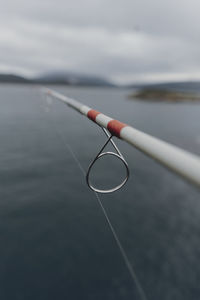 Close-up of water drop on lake against sky