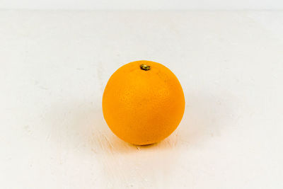 High angle view of orange slice against white background