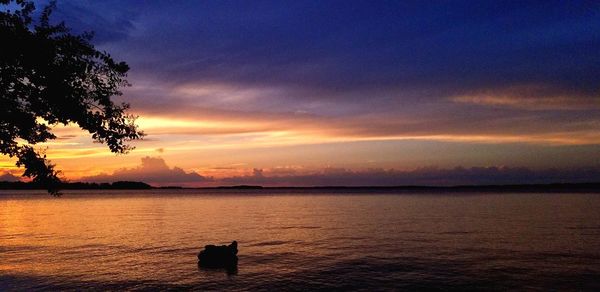 Scenic view of sea against orange sky