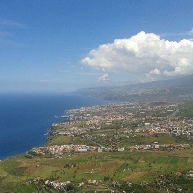 sea, sky, scenics, landscape, tranquil scene, water, high angle view, beauty in nature, tranquility, blue, horizon over water, nature, building exterior, mountain, aerial view, coastline, built structure, cloud - sky, architecture, cloud