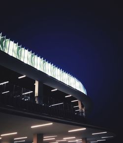 Low angle view of illuminated building against sky at night