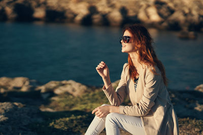 Young woman sitting on rock