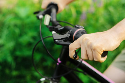 Midsection of person holding bicycle