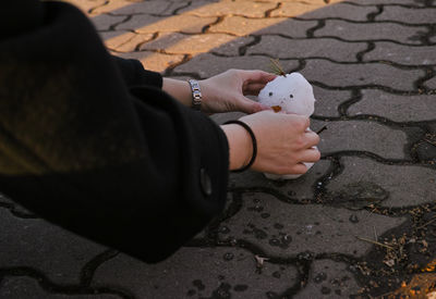 Cropped hand of woman making snowman