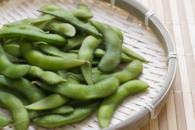 Green japanese soybeans in basket on table