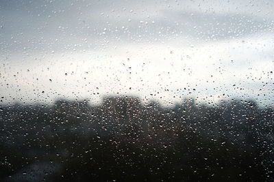 Full frame shot of wet glass window during rainy season