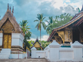 Temple by building against sky