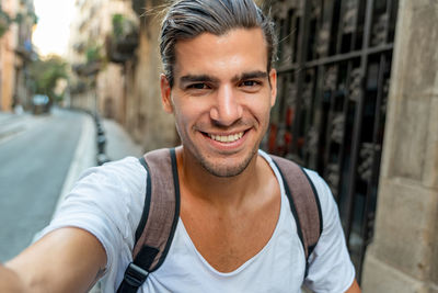 Selfie of young latin man smiling in the city