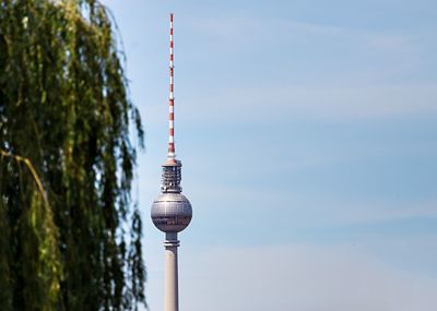 Low angle view of communications tower against sky