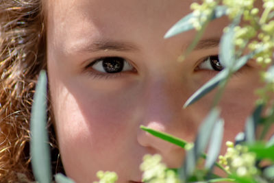 Close-up portrait of cute girl with plants