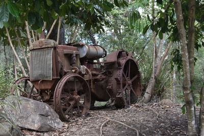 Abandoned cart against trees