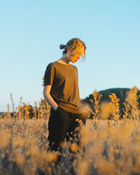 Man standing on field against clear sky