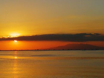 Scenic view of sea against romantic sky at sunset