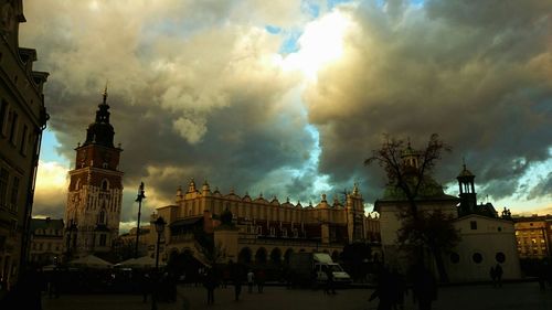 Buildings against cloudy sky