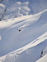 High angle view of people skiing on snow covered mountain