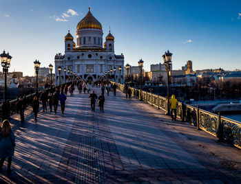 People walking on patriarshy bridge leading towards temple of christ the savior