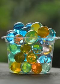 Close-up of multi colored glass on table