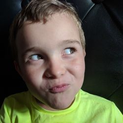 Close-up of smiling boy looking away