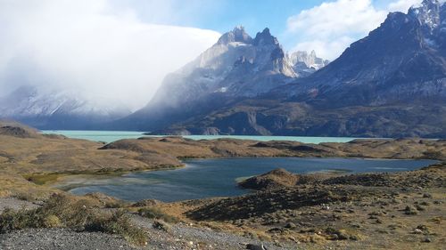 Scenic view of lake and mountains against sky