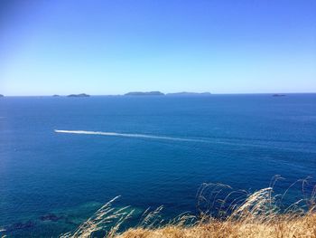 Scenic view of sea against clear blue sky