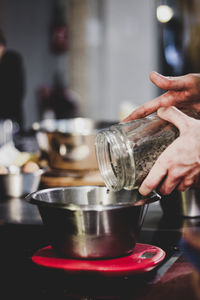 Midsection of person preparing food in kitchen