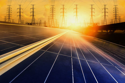 Light trails on road against sky during sunset