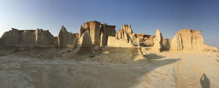 Panoramic view of desert against clear sky