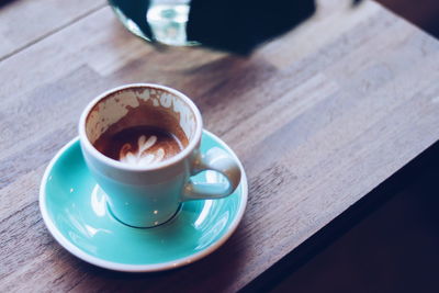 High angle view of coffee cup on table