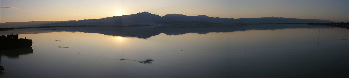 Scenic view of lake against sky during sunset