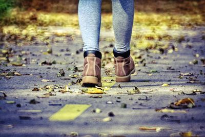 Low section of man standing on road