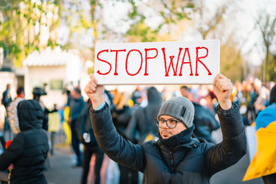 Protestor holding placard at anti-war rally