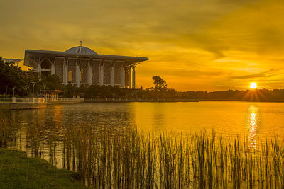 Scenic view of lake against sky during sunset