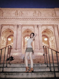 Woman standing in corridor of building
