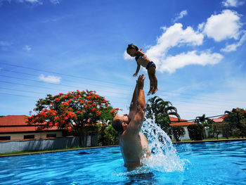 Father and daughter have fun in the pool