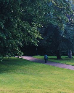 Man on golf course against trees