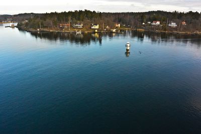 Scenic view of lake with houses in background