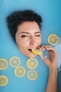Portrait of young man drinking glass