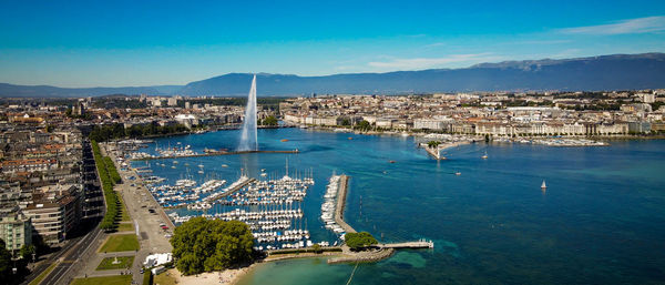 High angle view of city by sea against sky