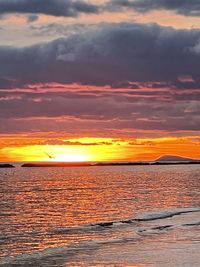 Scenic view of sea against romantic sky at sunset